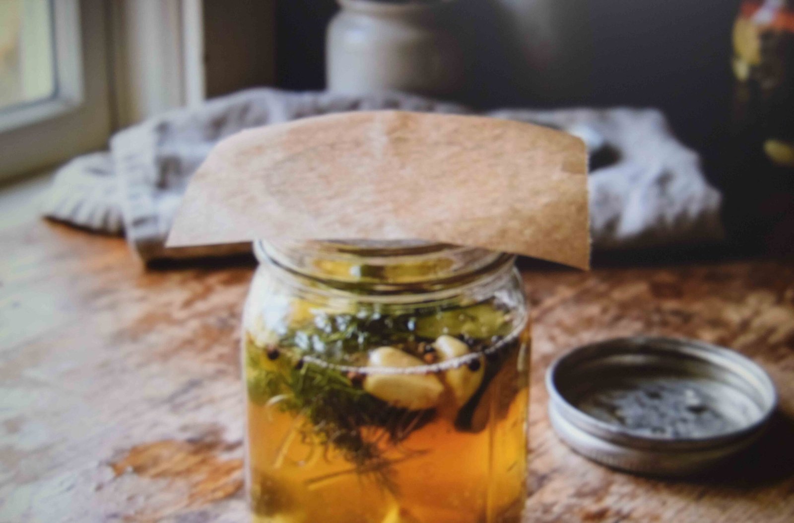 Parchment laid over a jar mouth to stop the metal lid corroding
