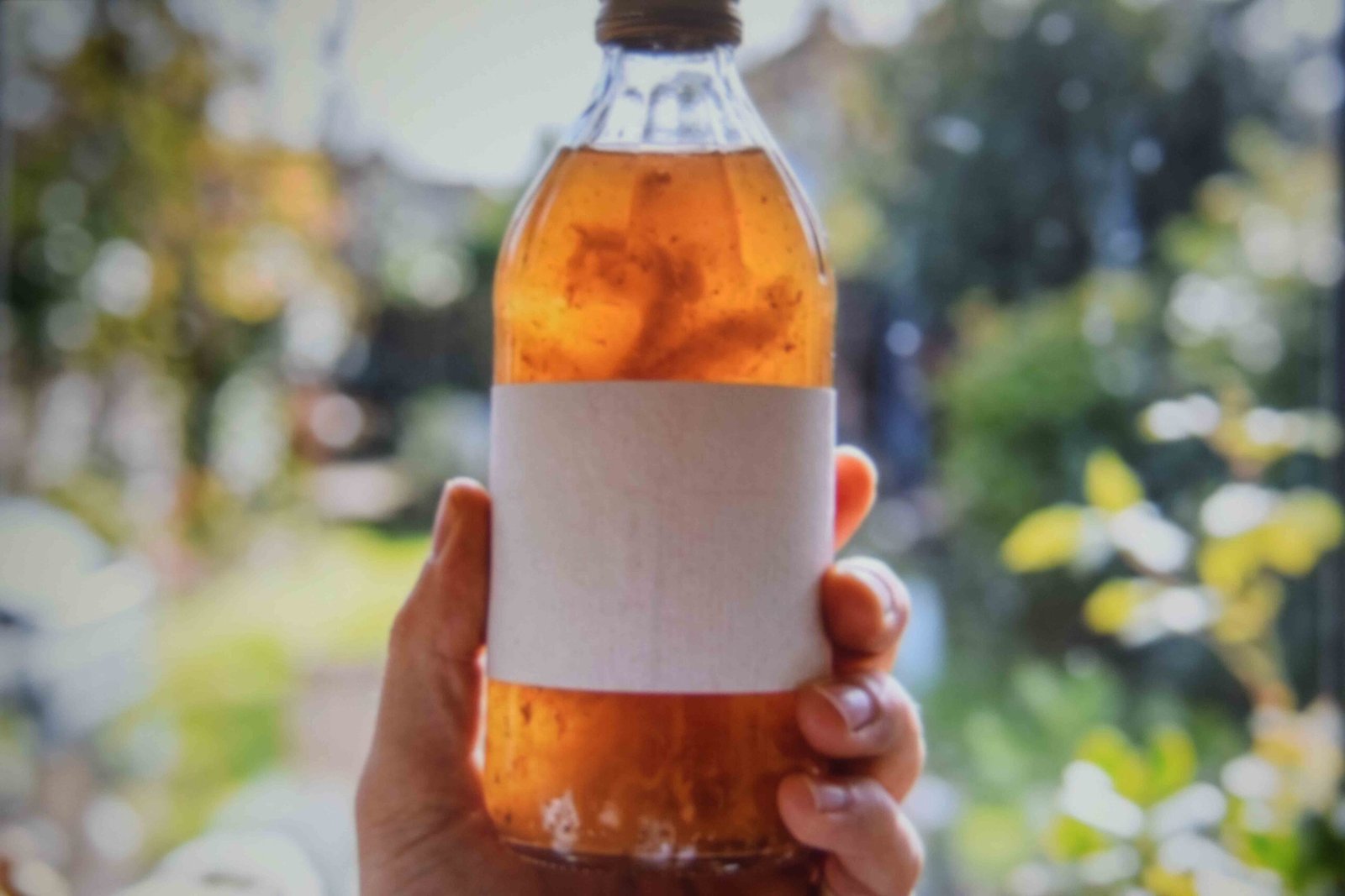 Cloudy raw apple cider vinegar with sediment settled at the bottom
