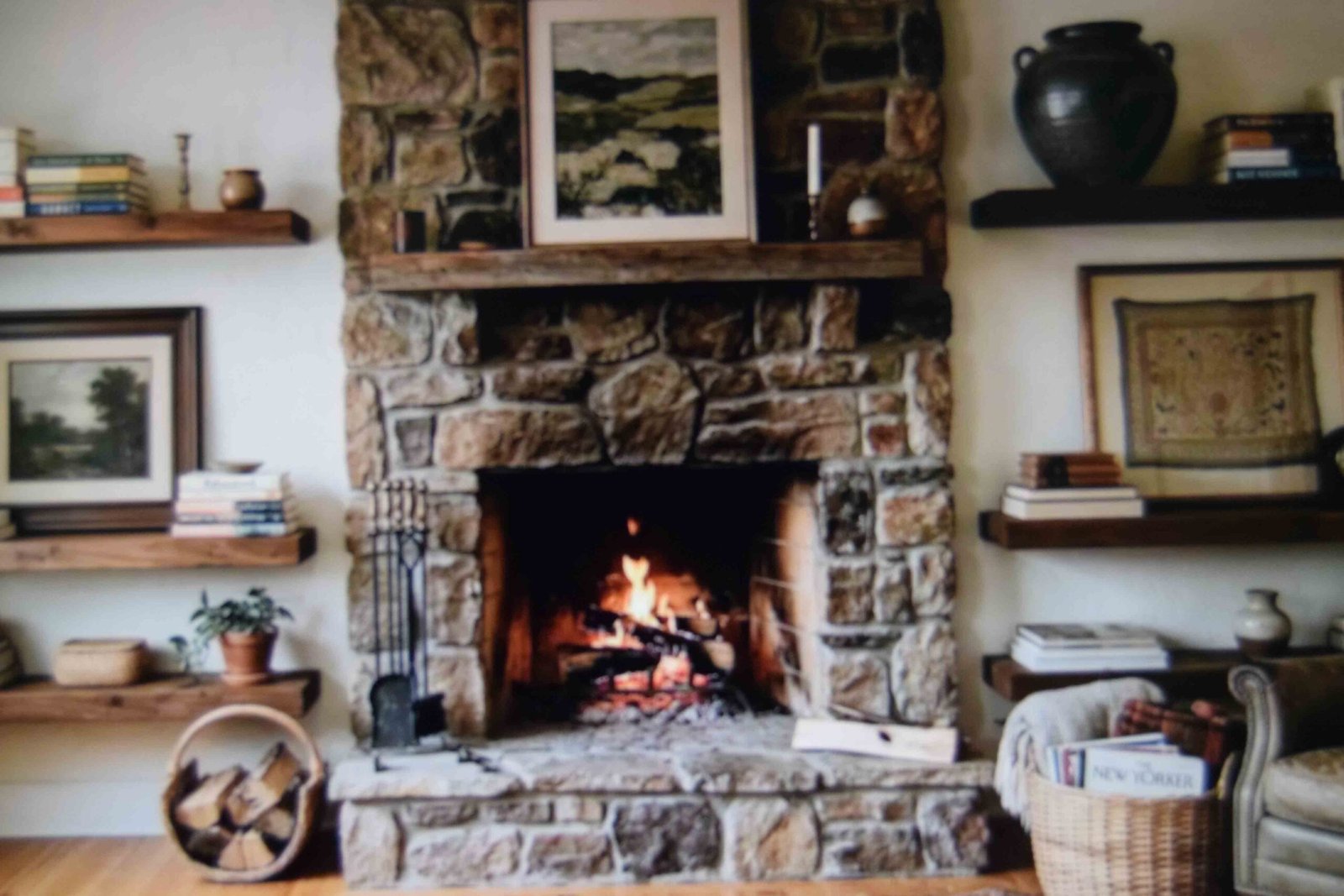 Floating shelves flanking a fireplace styled with books and ceramics