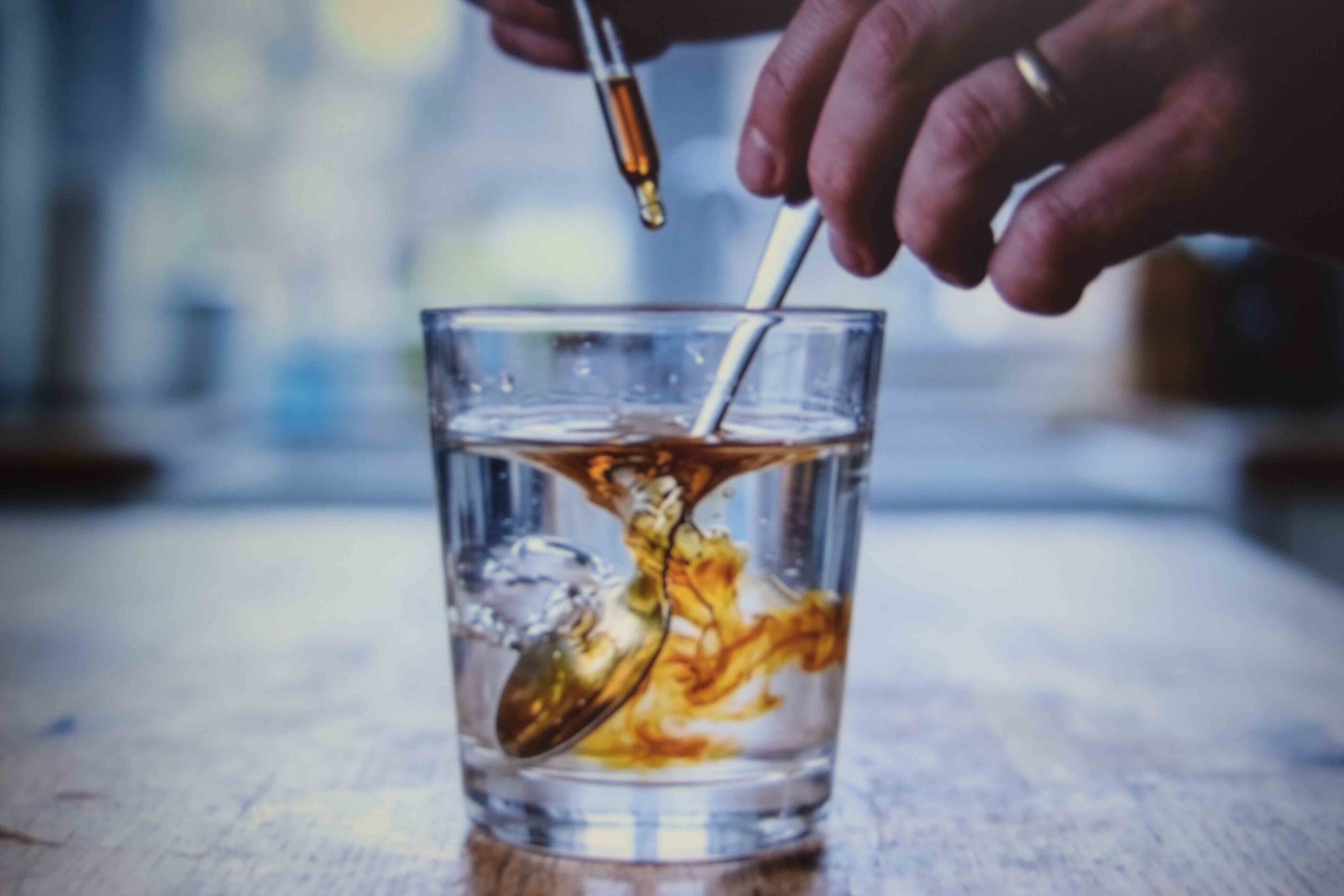 A spoonful of fire cider diluted into a glass of water before drinking