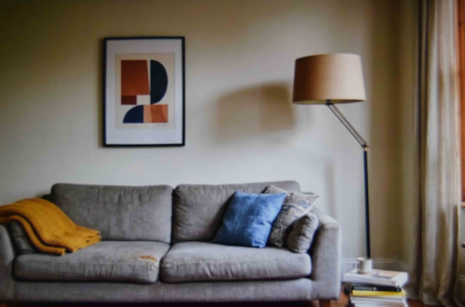 Art hung off to one side with a floor lamp balancing the other end