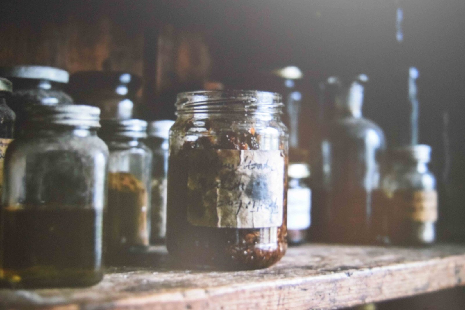 A dated jar steeping in a dark cupboard away from sunlight